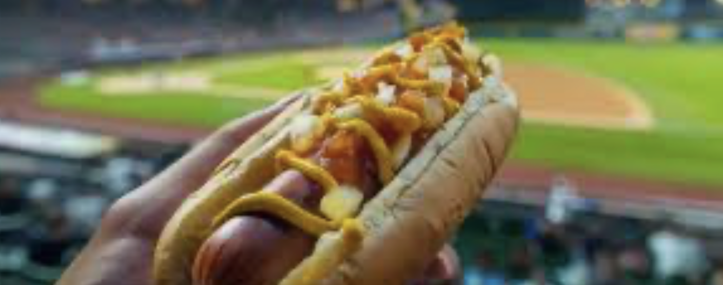 Hot-dog Style Stade : saucisse grillée, oignons sautés, moutarde jaune et fromage dans un pain toasté